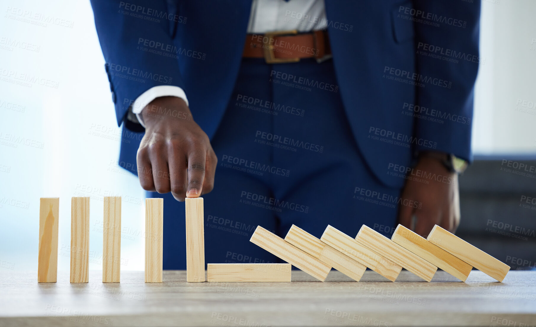 Buy stock photo Shot of an unrecognisable businessman working with falling wooden blocks