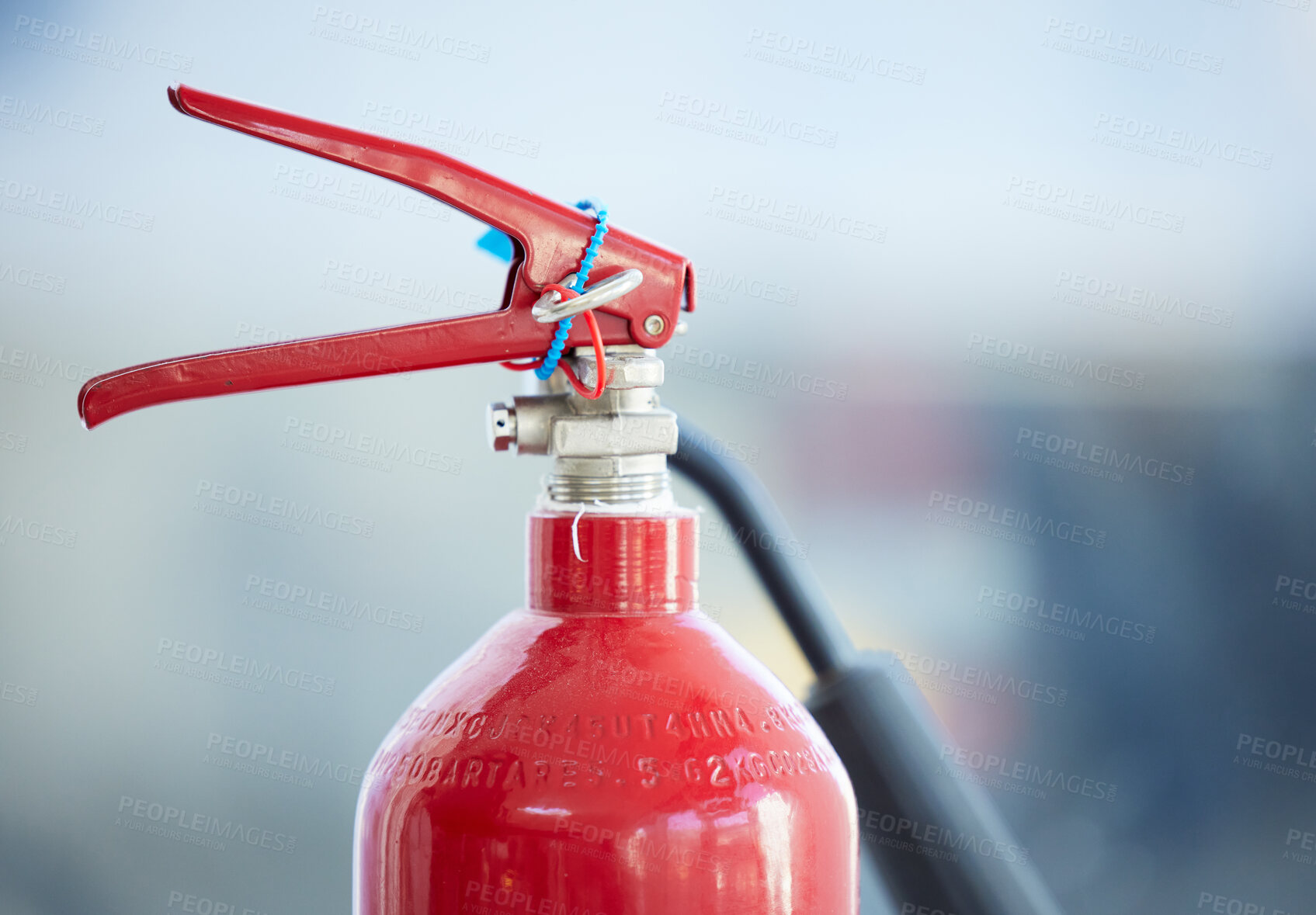 Buy stock photo Shot of a red fire extinguisher