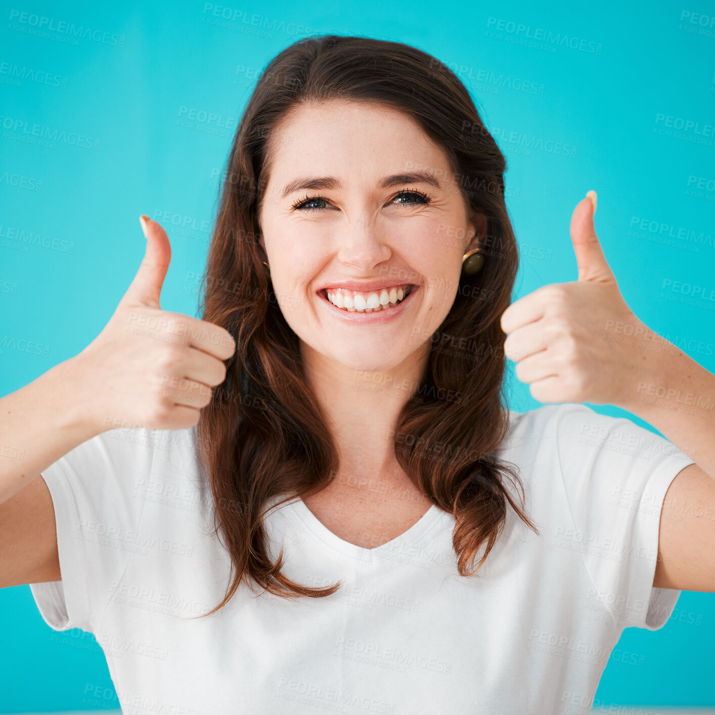 Buy stock photo Woman, portrait and thumbs up in studio for motivation, approval and agreement with smile. Happy, person and hand gesture on blue background for support, good job and pride for achievement with emoji