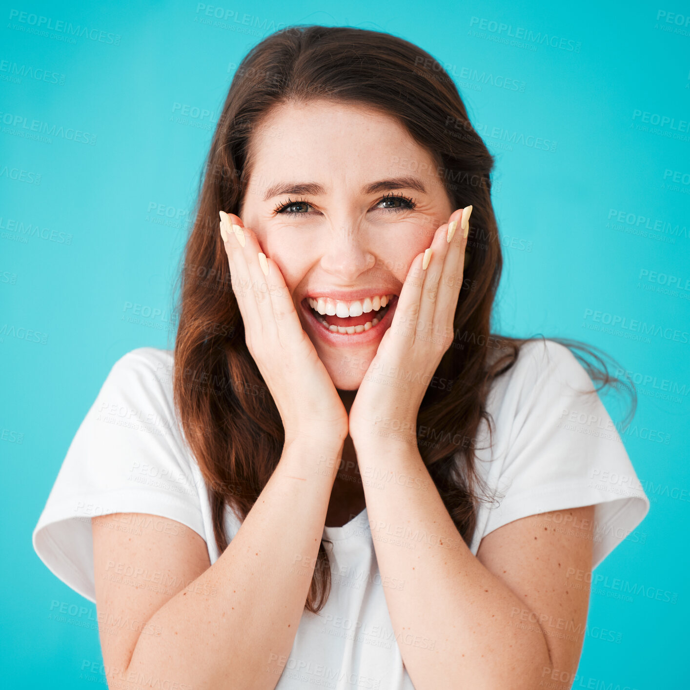 Buy stock photo Studio portrait of an attractive young woman looking surprised against a blue background