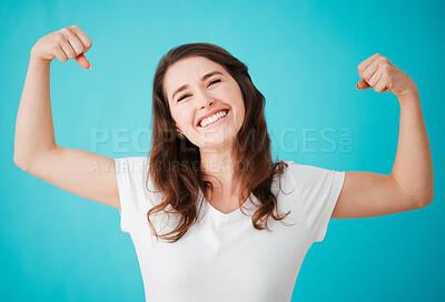 Buy stock photo Woman, studio and happy with biceps for strength or power and confidence on blue background as life coach. Female person, portrait and excited or smile for motivation, positivity and hope with flex