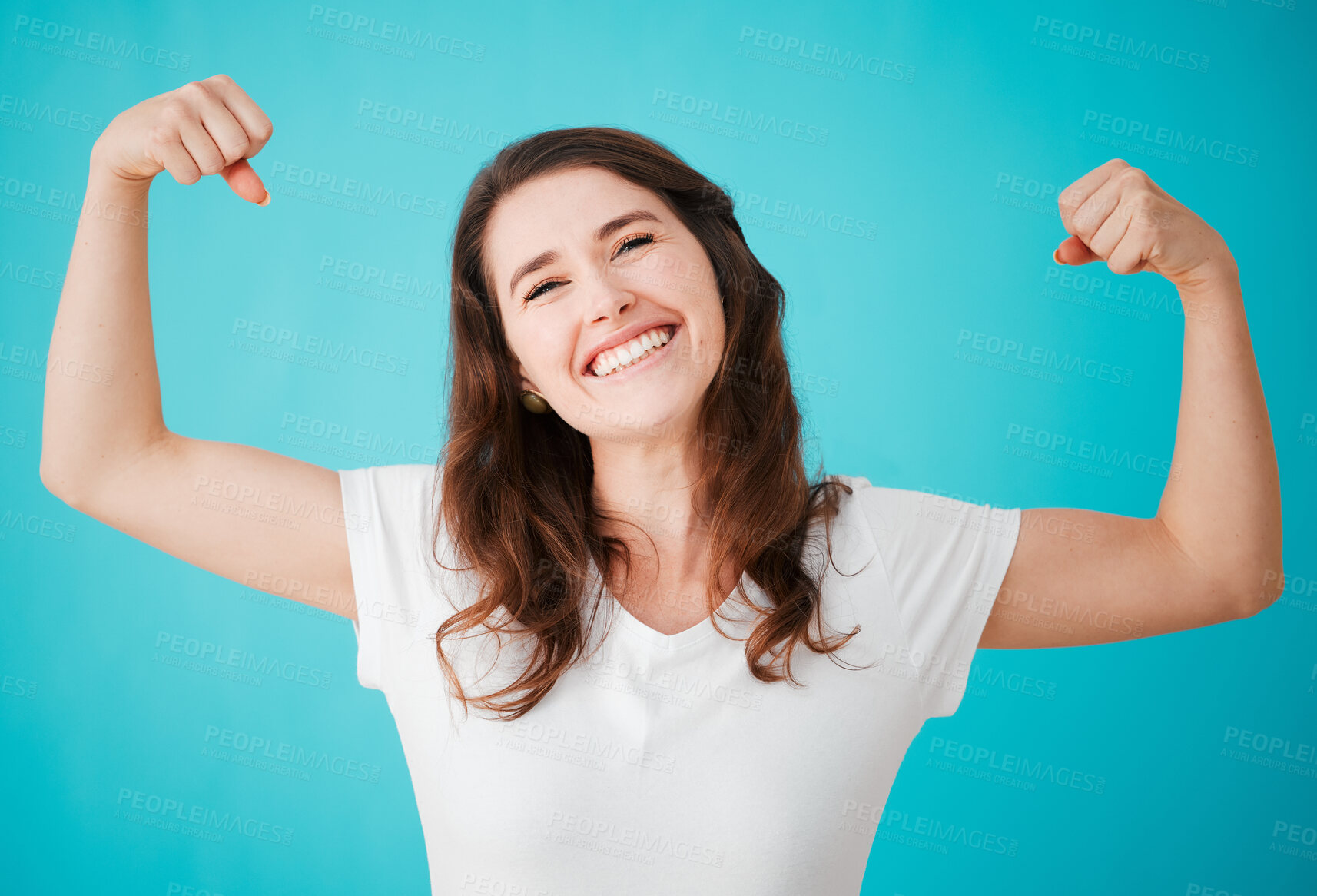 Buy stock photo Woman, studio and happy with biceps for strength or power and confidence on blue background as life coach. Female person, portrait and excited or smile for motivation, positivity and hope with flex