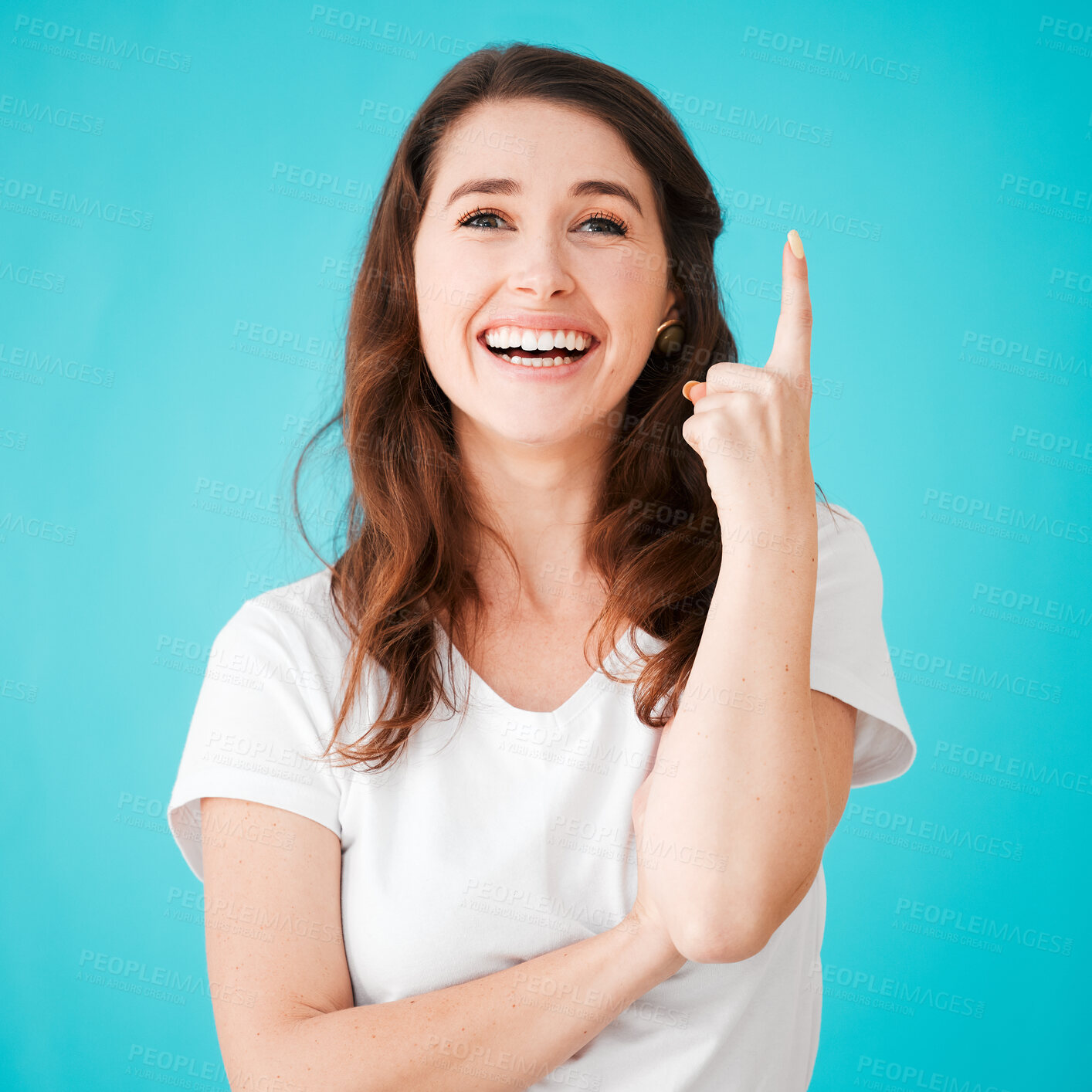 Buy stock photo Portrait, happy woman and pointing up in studio for idea, presentation or show information. Face, excited and model with hand gesture for ads, discount deal or coming soon isolated on blue background