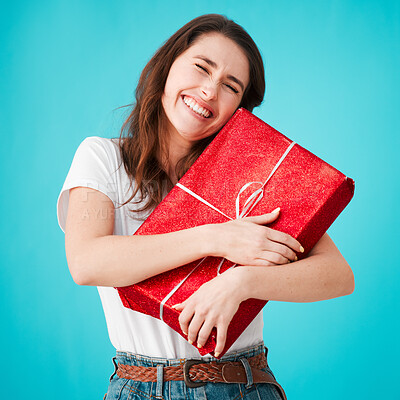 Buy stock photo Woman, studio and happy with gift in box or package with smile, eyes closed and laugh on blue background. Female person, excited and Christmas present in festive season giveaway product and prize