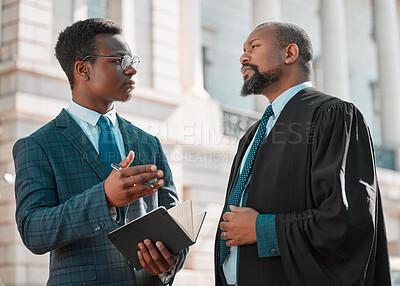 Buy stock photo Shot of two male lawyers talking in the city