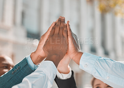 Buy stock photo Shot of a group of unrecognizable businesspeople giving each other a high five in the city