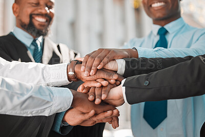 Buy stock photo Shot of a group of businesspeople stacking their hands in the city