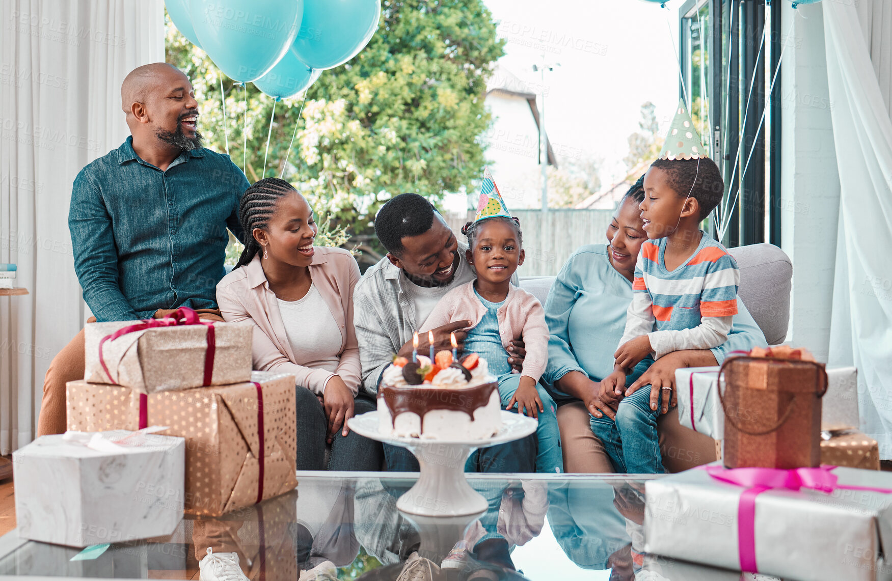 Buy stock photo Birthday cake, gifts and portrait of black child with family at party with balloons for celebration at home. Happy, presents and girl with dessert for event with grandparents, parents and brother.