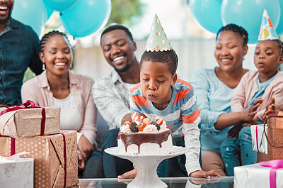 Buy stock photo Shot of a boy blowing out candles at his birthday party