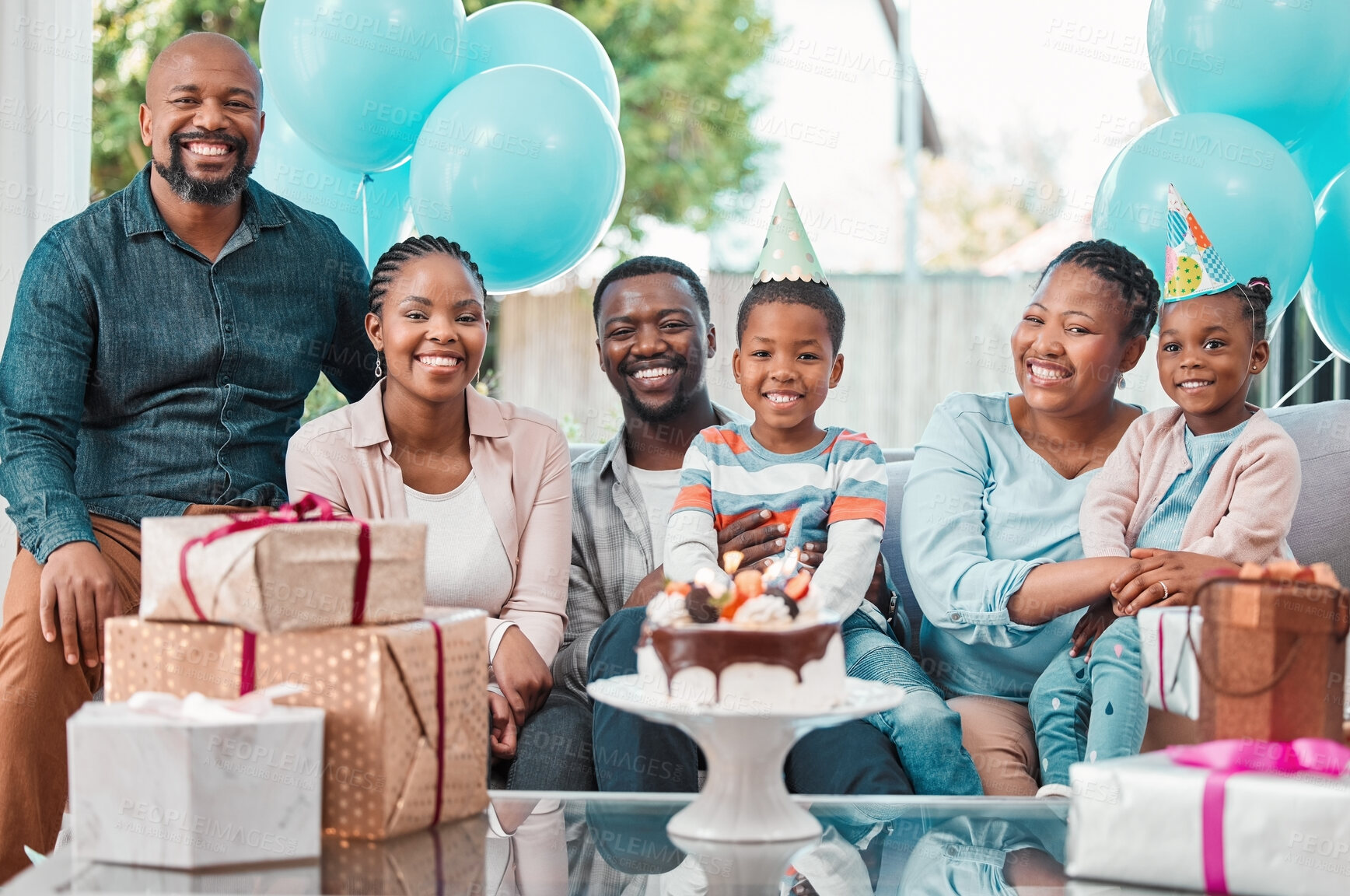 Buy stock photo Shot of a multi-generational family celebrating a birthday at home