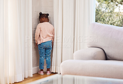 Buy stock photo Shot of a little girl standing in the corner as a punishment at home