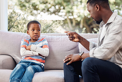 Buy stock photo Shot of a little boy being scolded b his father at home
