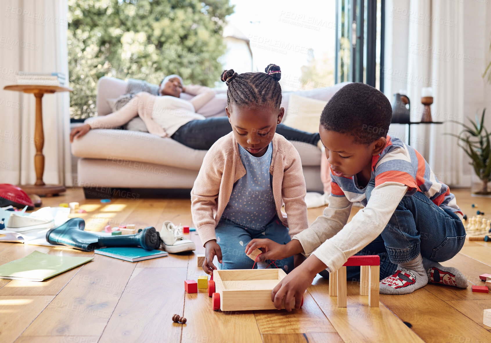 Buy stock photo Children, games and toys on floor for development, relationship growth or tired mom on sofa. ADHD kids, messy or keeping busy in home for bonding, learning or creative with building blocks for play