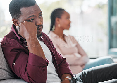 Buy stock photo Shot of a young couple ignoring each other during an argument