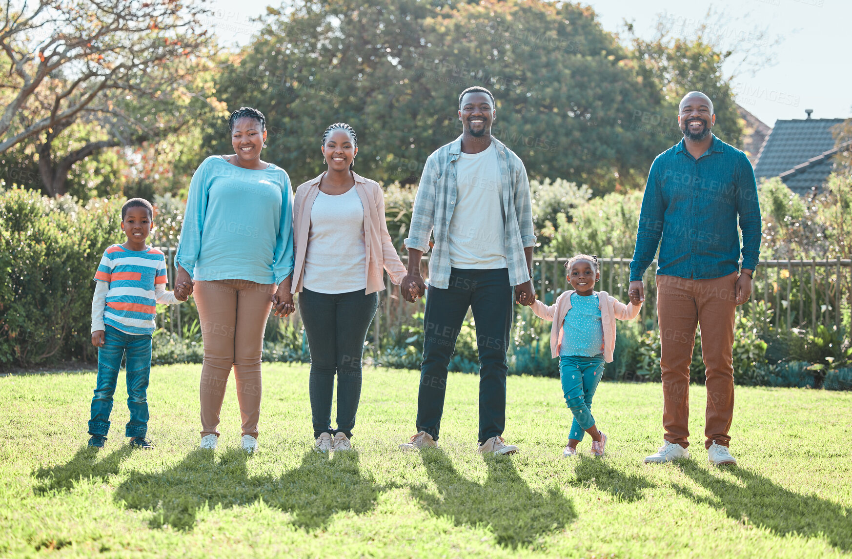 Buy stock photo Portrait, happy big family and holding hands outdoor for trust, people bonding or smile. African mother, father and grandparents with children at backyard for care, love and connection of generations