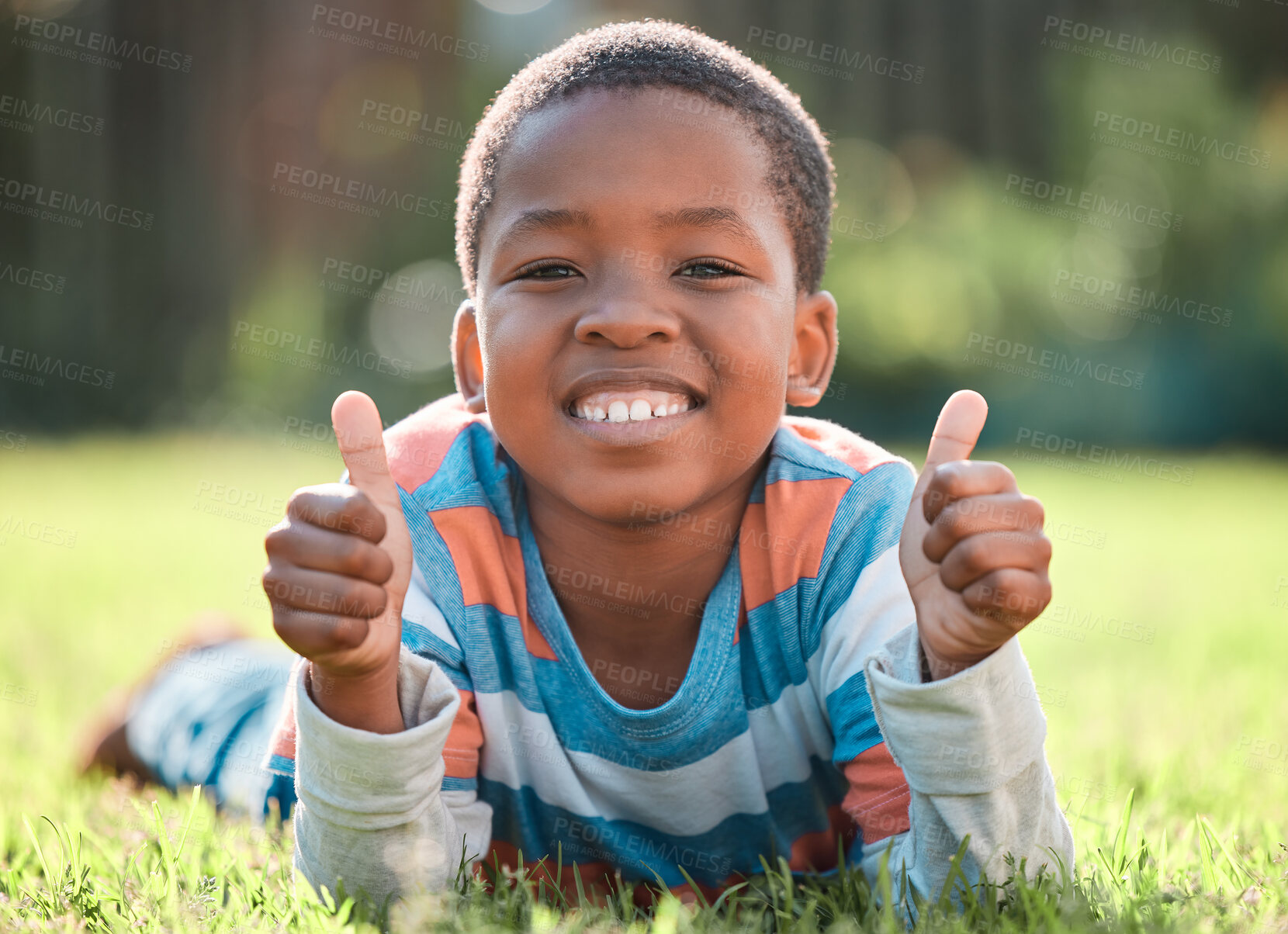 Buy stock photo Boy, portrait and thumbs up in park on grass for summer, development and weekend break with like. Black child, happy and thank you in nature for school vacation, relax and fun childhood with approval