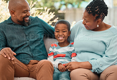 Buy stock photo Shot of a little boy spending time with his grandparents at home