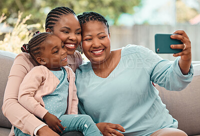 Buy stock photo Shot of a family taking selfies together at home