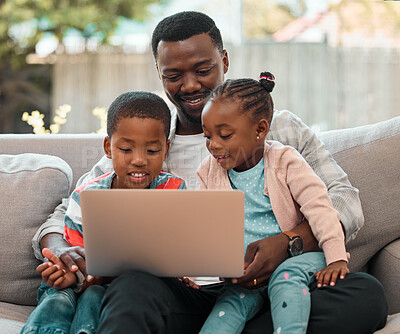 Buy stock photo Shot of a young father using a laptop with his children at home