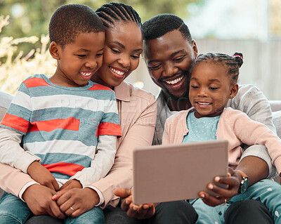 Buy stock photo Shot of a family using a digital tablet together at home