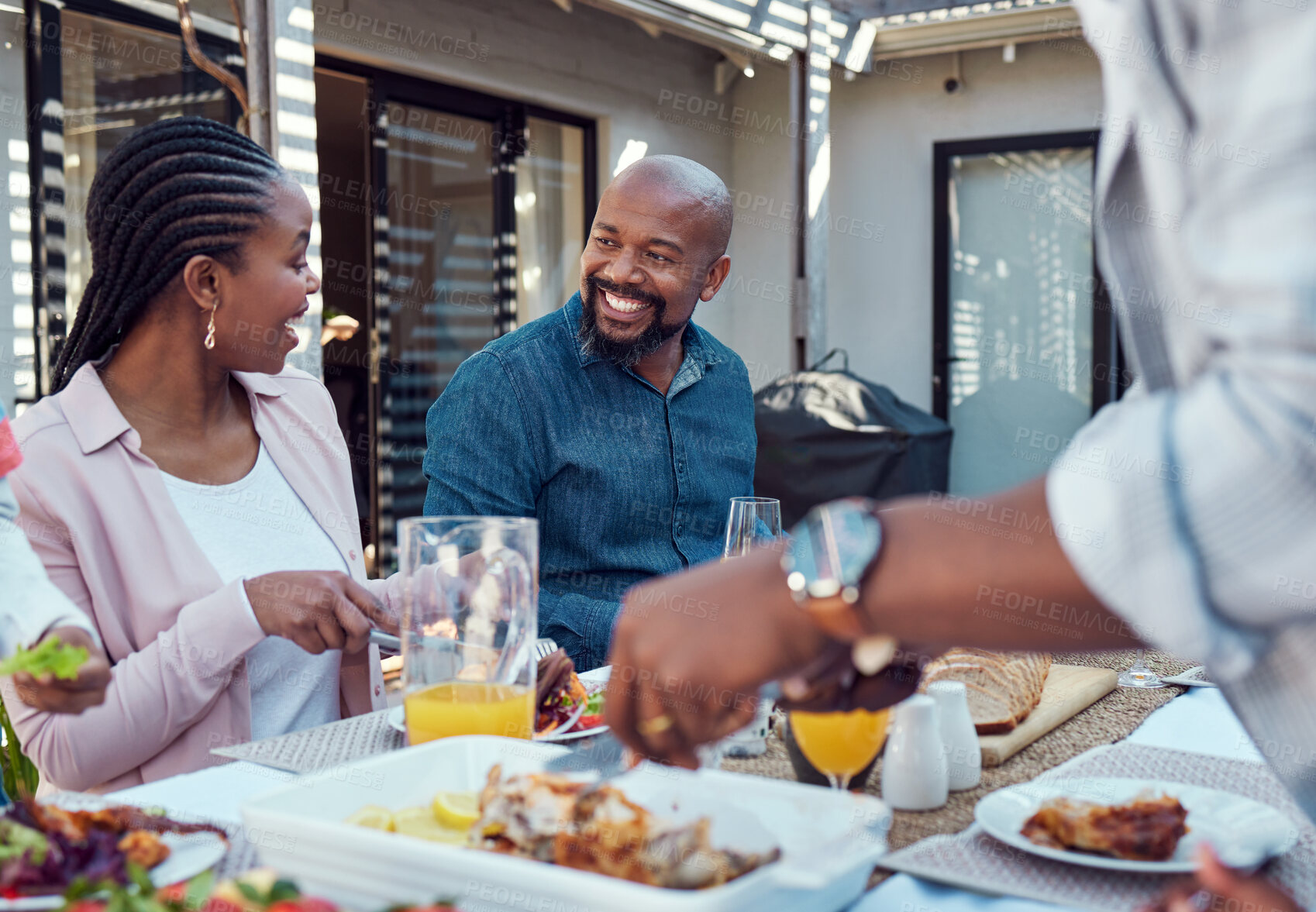 Buy stock photo Outdoor, black family and food with event, happiness and bonding together with conversation. Group, parents or healthy meal in garden, celebration or cheerful with nutrition, home or social gathering