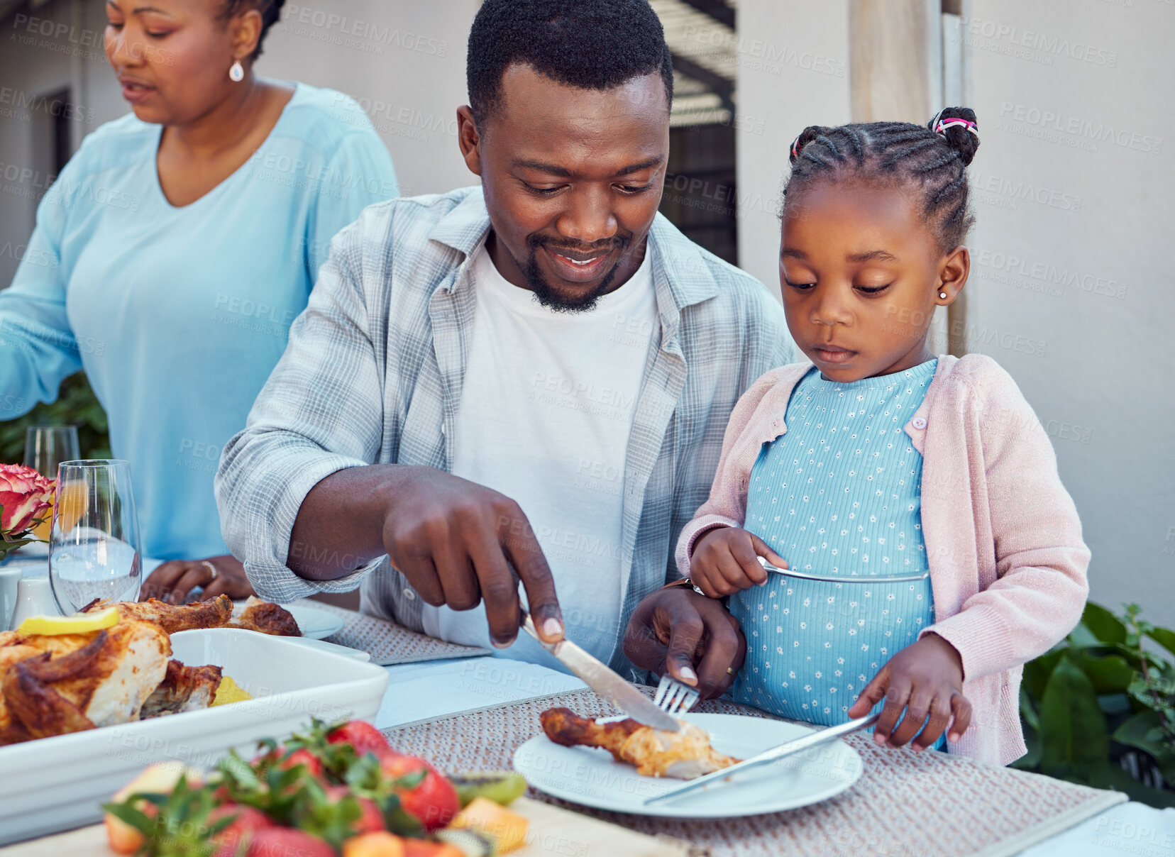 Buy stock photo Black family, lunch and man with child by home for event, conversation and eating together at reunion. African people, love and happy with food at table in backyard for meal, nutrition and bonding