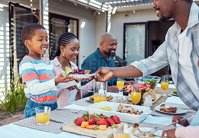 Buy stock photo Outdoor, black family and food with event, smile and bonding together with conversation. Serving, parents or healthy meal in garden, celebration or happiness with nutrition, home or social gathering