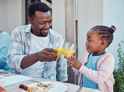 Buy stock photo Outdoor, black family and cheers with event, juice and bonding together with conversation. Girl, father or healthy meal in garden, celebration or happiness with nutrition, house or social gathering