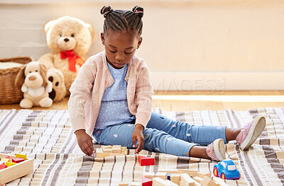 Buy stock photo African child, playing and building blocks in game for growth, development and learning for motor skills. Toddler, toys and puzzle in education, creativity or fun for cognitive ability in family home