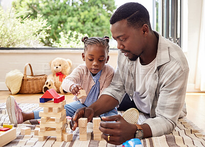 Buy stock photo Shot of a little girl playing with blocks with her father at home