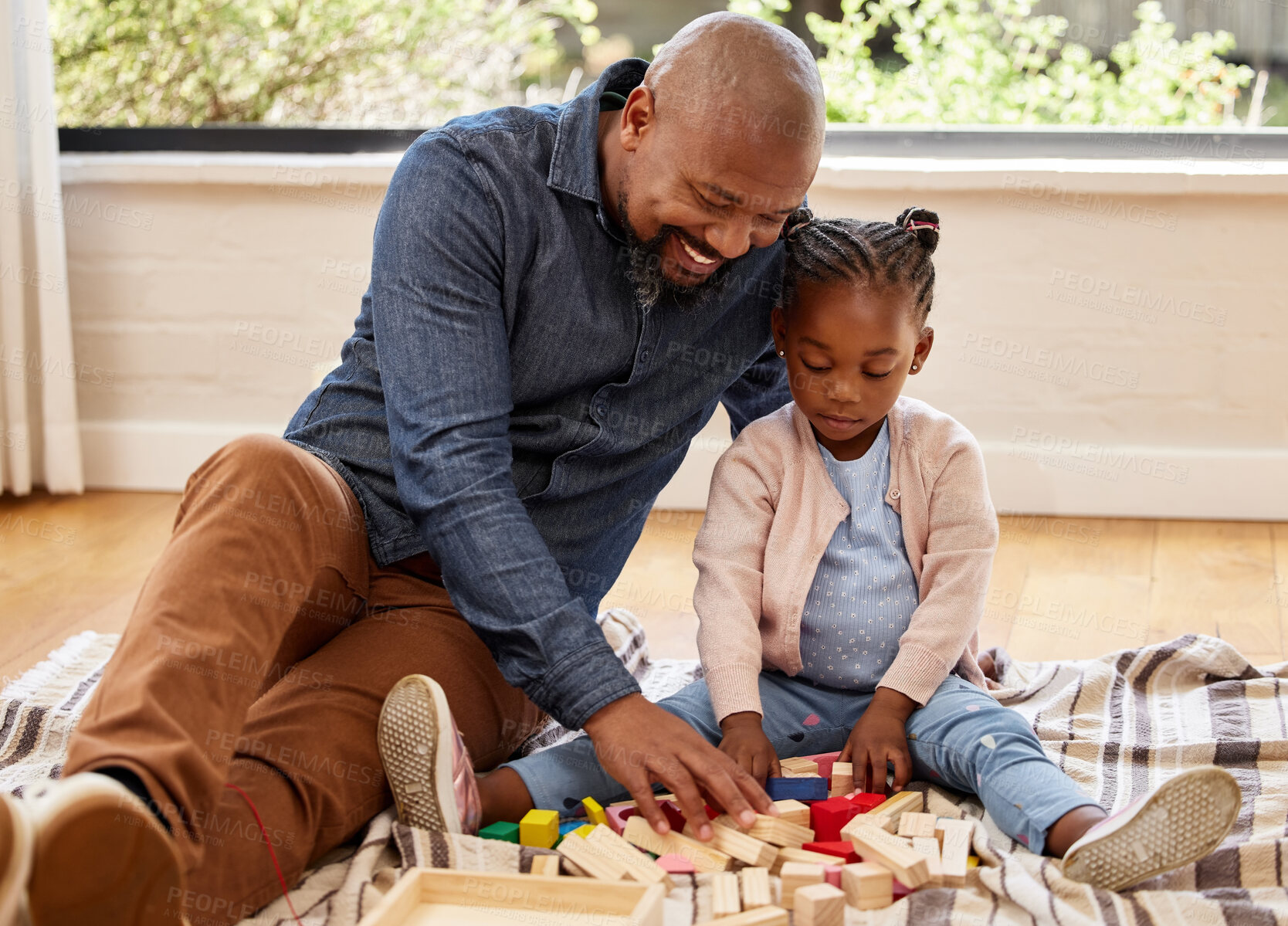 Buy stock photo Shot of s little girl plsying with blocks with her grandpa at home