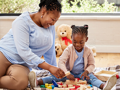 Buy stock photo Shot of a little girl playing with blocks with her grandma at home