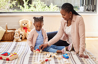 Buy stock photo Shot of a little girl playing with blocks with her mother at home