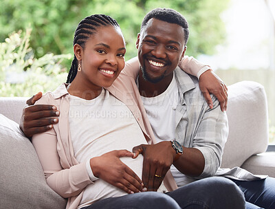 Buy stock photo Cropped portrait of an affectionate young couple of parents to be sitting on the sofa at home