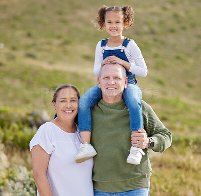 Buy stock photo Shot of a mature couple spending time outdoors with their granddaughter