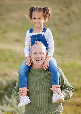 Buy stock photo Shot of a man spending time outdoors with his granddaughter