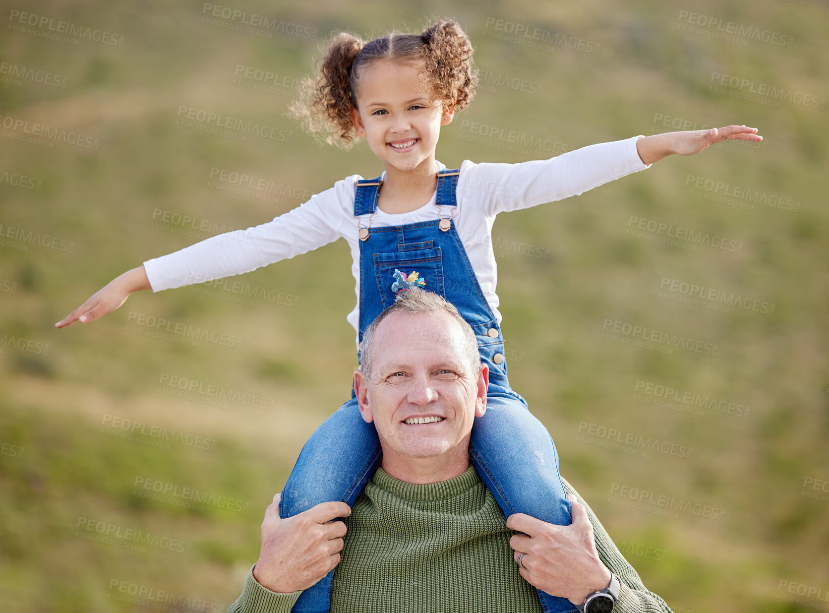 Buy stock photo Shot of a man spending time outdoors with his granddaughter