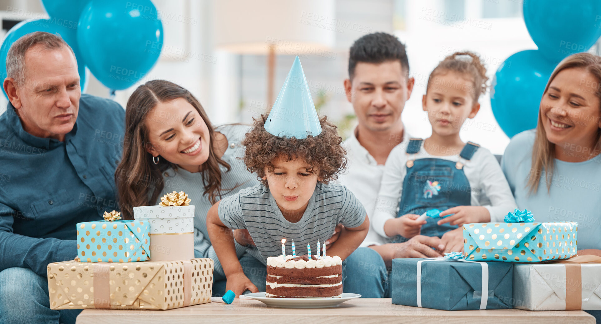 Buy stock photo Shot of an adorable little boy celebrating a birthday with his family at home