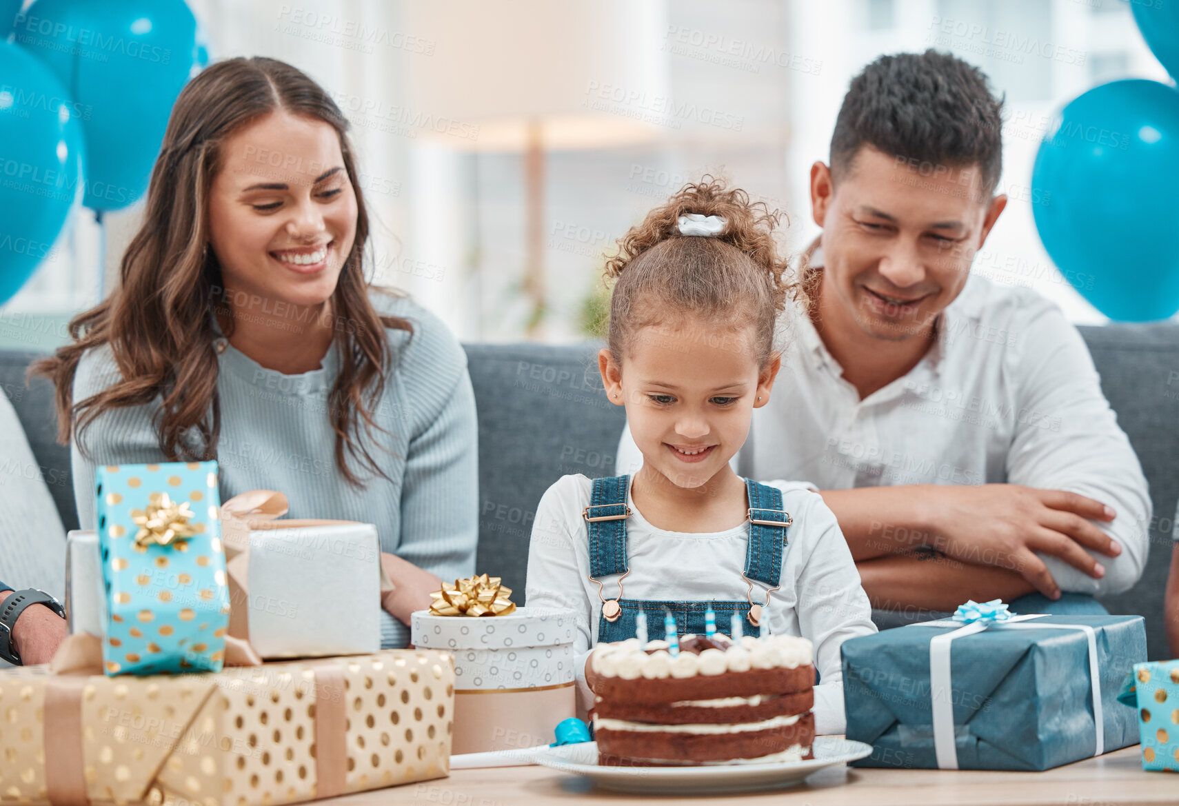 Buy stock photo Birthday, cake and candles with family in living room for celebration, balloons and milestone event. Gift giving, love and support with people and party at home for growth, care and gathering.