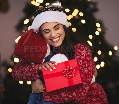 Buy stock photo Shot of a young mother and daughter exchanging Christmas gifts at home
