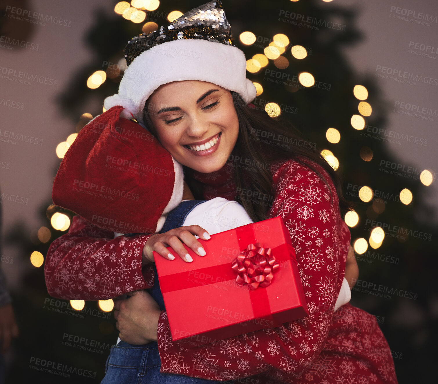 Buy stock photo Christmas, mother and girl with gift, hug and bonding together with festive season, house and holiday. Xmas, family and parent with mama, daughter and present with embrace, vacation and celebration