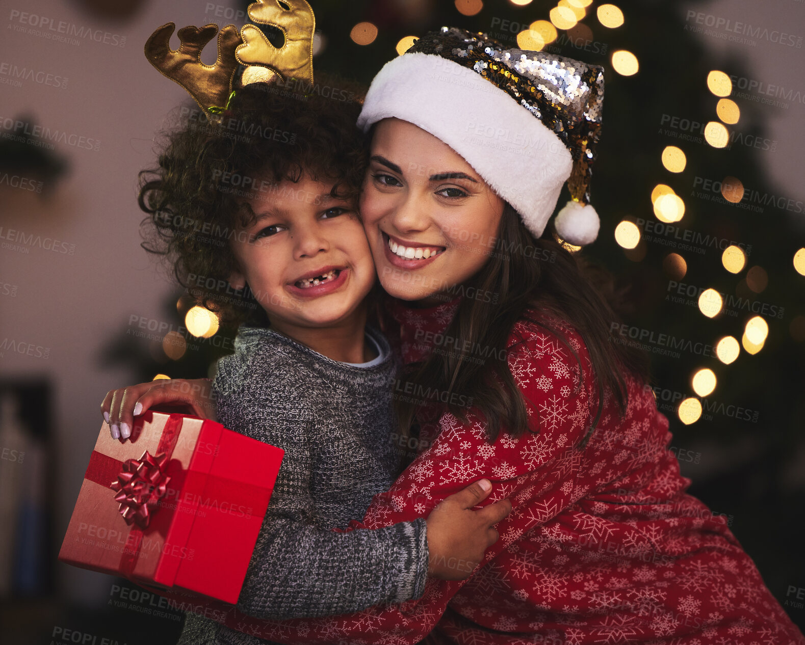 Buy stock photo Shot of a young mother and son exchanging Christmas gifts at home