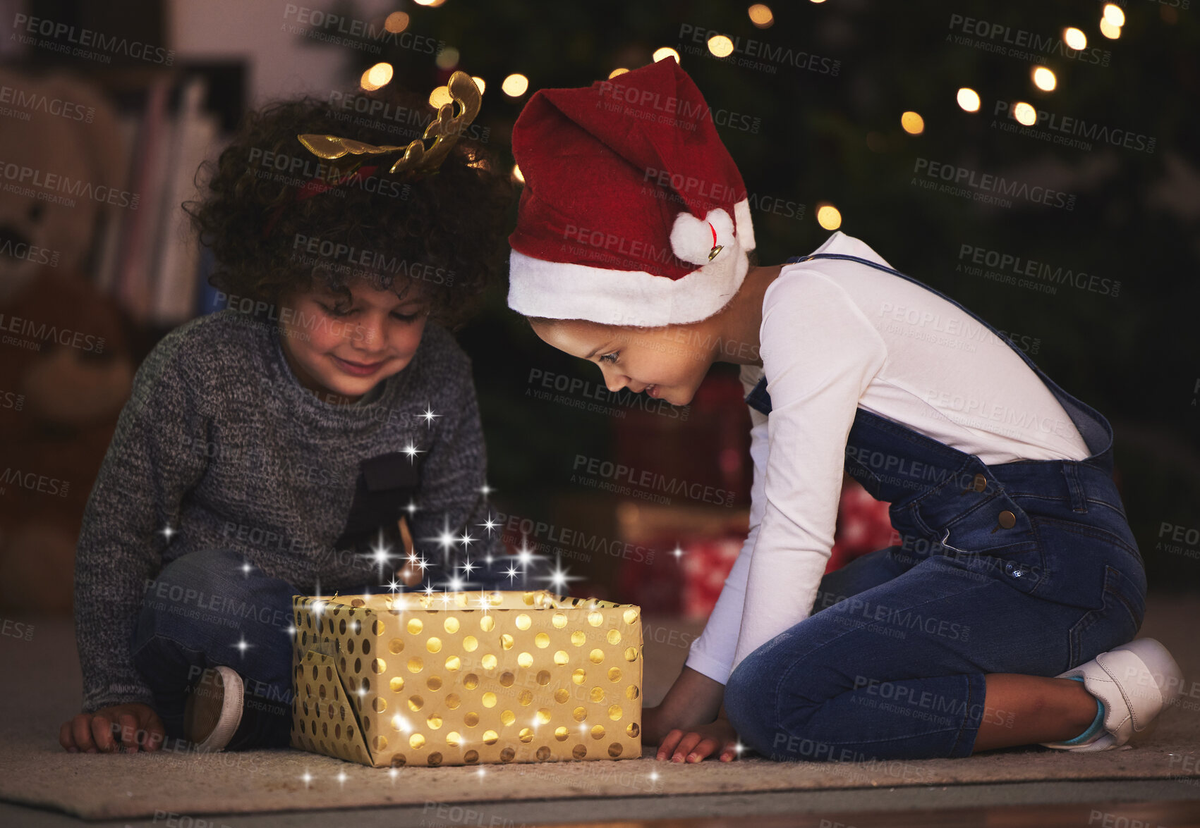 Buy stock photo Christmas, gift giving and magic with children and box for festive glow, Noel cheer and xmas celebration. Happy, winter holiday and decorations with kids in family home for present, sparkle or light