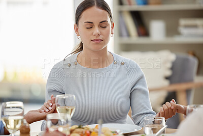 Buy stock photo Shot of a young girl closing her eyes for prayer time before lunch at home with her family