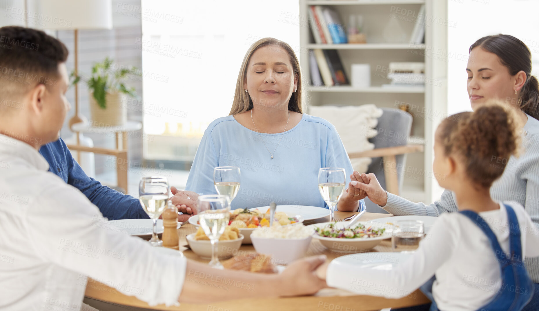 Buy stock photo Faith, big family and prayer with snack, holding hands and religion with healthy meal, nutrition or home. Praying, apartment or parents with girl, lunch or party with event, social gathering or calm