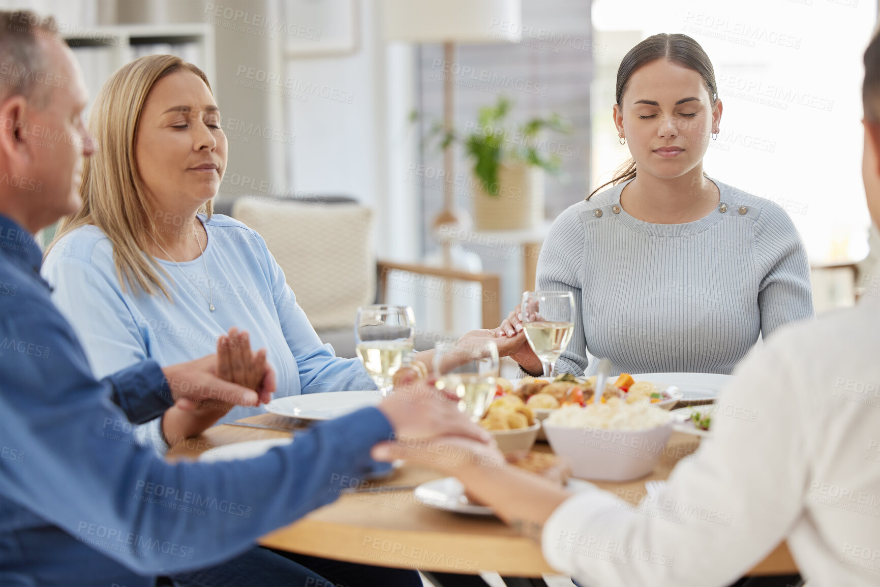 Buy stock photo Party, big family and prayer with food, holding hands and faith with healthy meal, nutrition and love. Praying, apartment or parents with girl, lunch or house with event, social gathering or religion