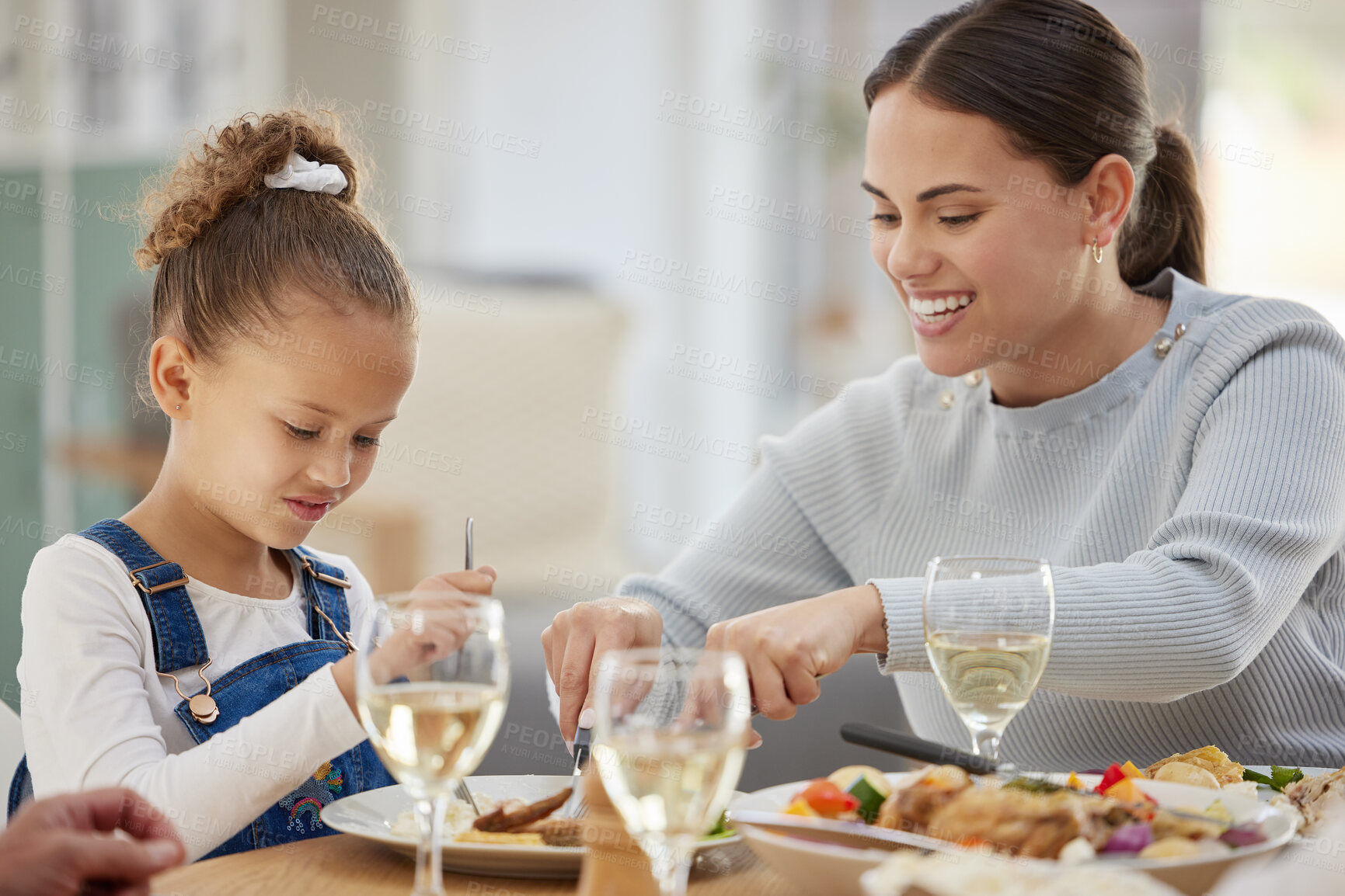 Buy stock photo Child, mother and food with family at dining room for Thanksgiving celebration, festive holiday and brunch. Support, love and party with people for nutrition, grateful and tradition at home together