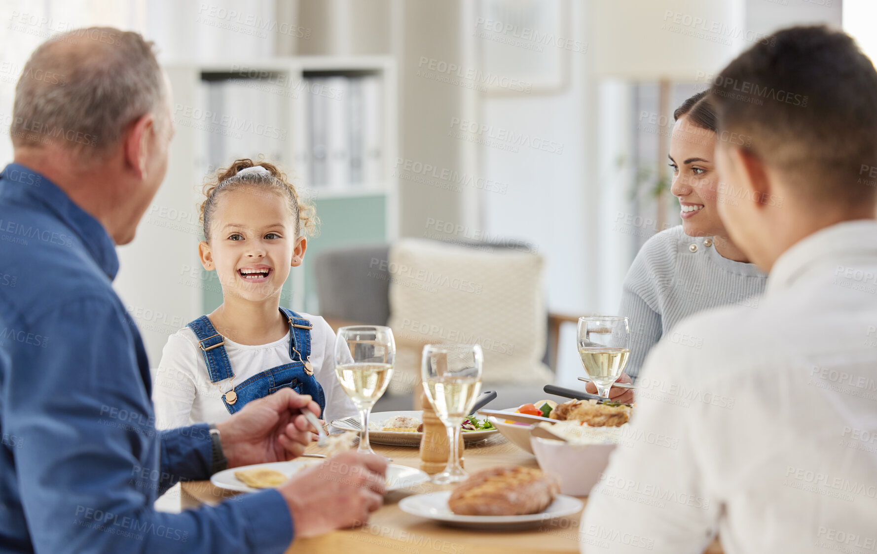 Buy stock photo Child, smile and food with family at dining room for Thanksgiving celebration, festive holiday and brunch. Support, love and party with people and dinner for nutrition, grateful and tradition at home