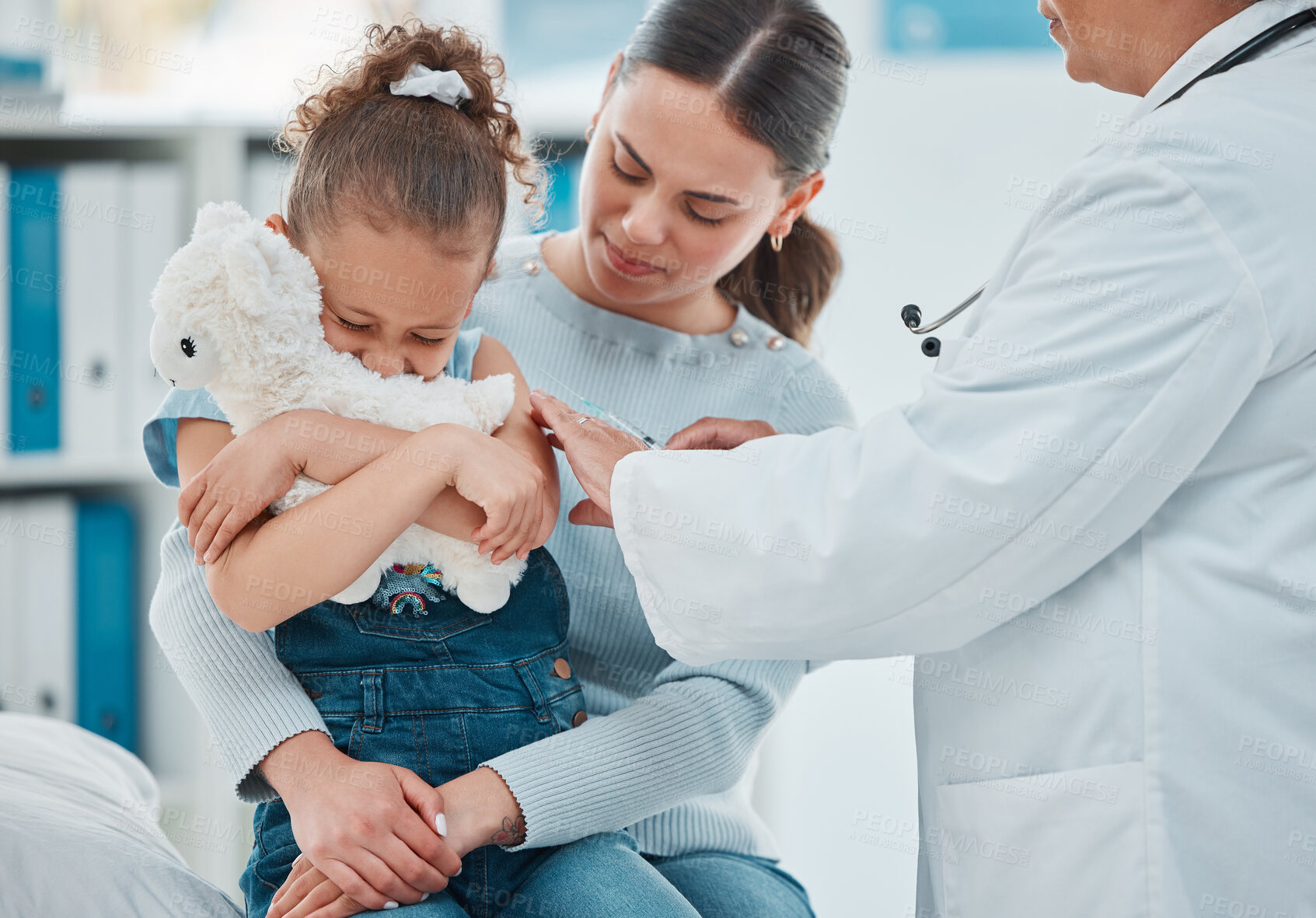 Buy stock photo Shot of a little girl looking scared while getting an injection from a doctor in a clinic