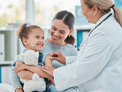 Buy stock photo Shot of a doctor using a cotton ball on a little girl's arm while administering an injection in a clinic